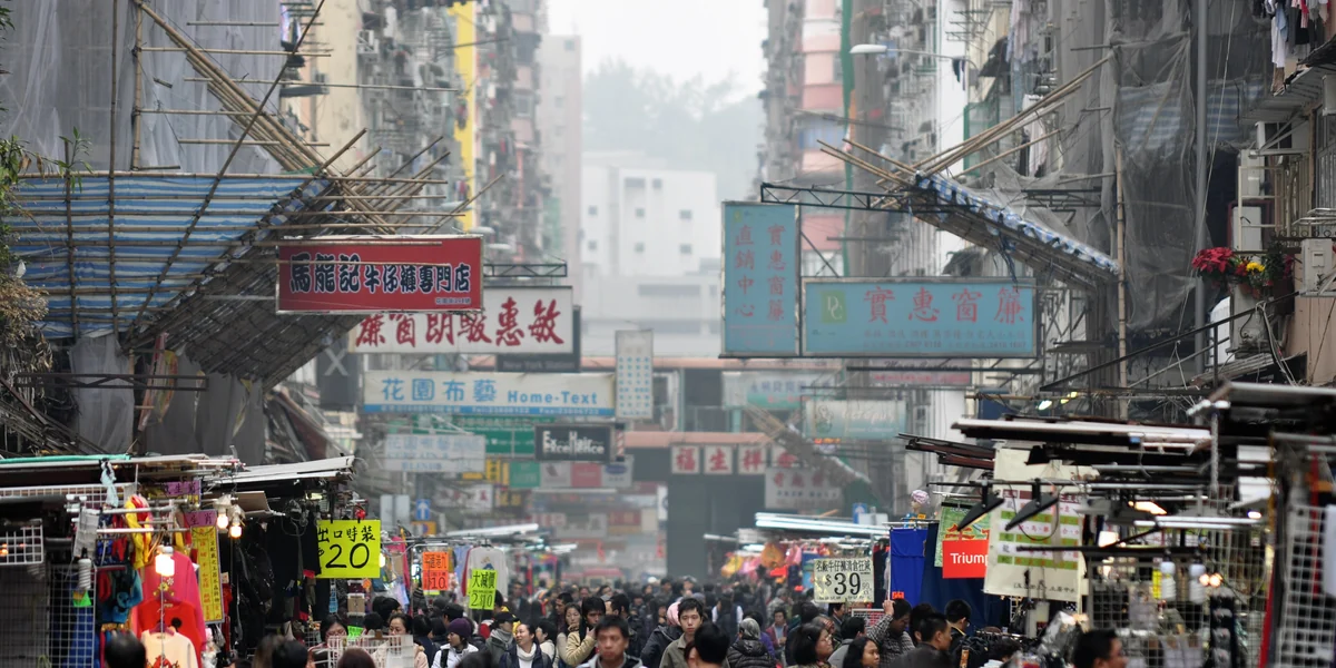 Wide view down Fa Yuen Street with market stalls and shoppers